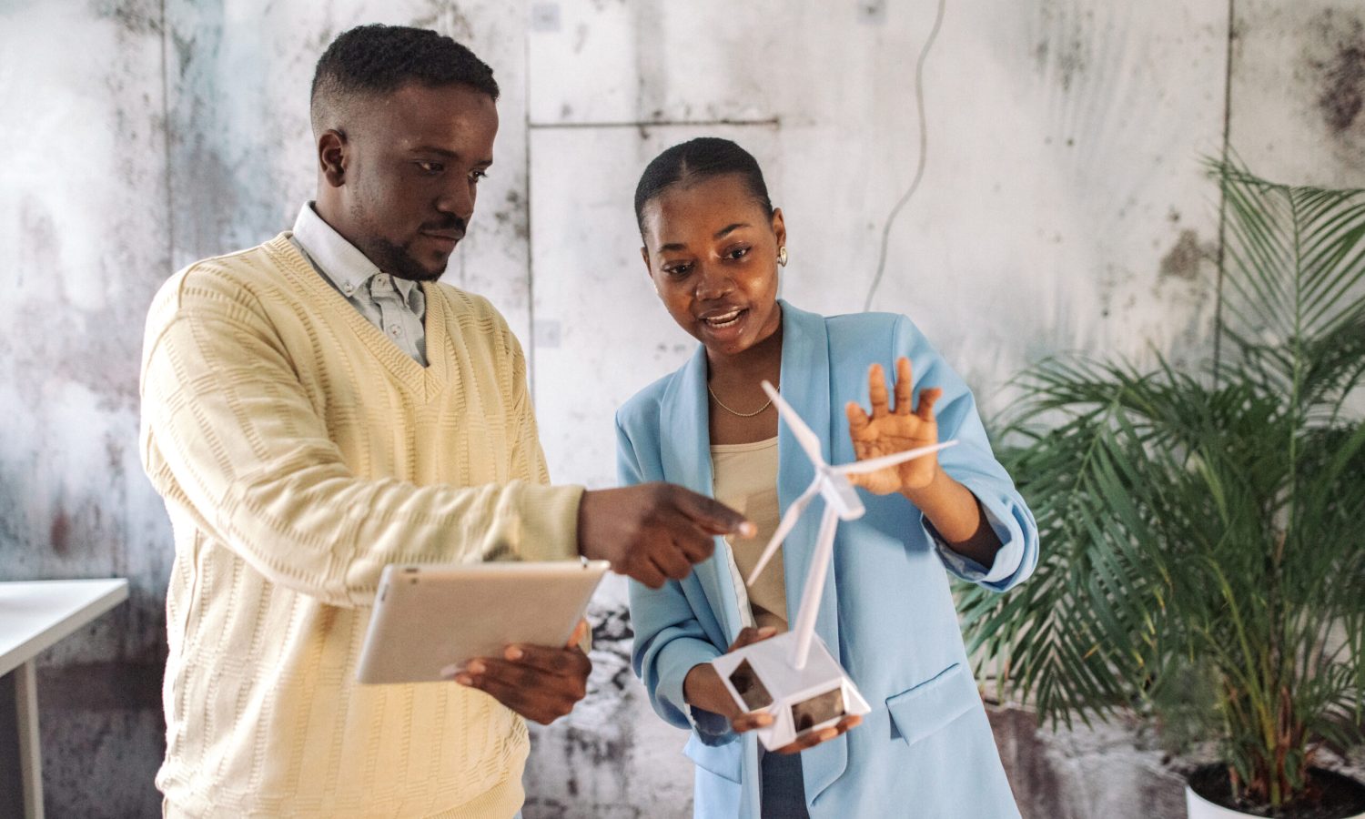 African colleagues in an office evaluating a wind turbine model